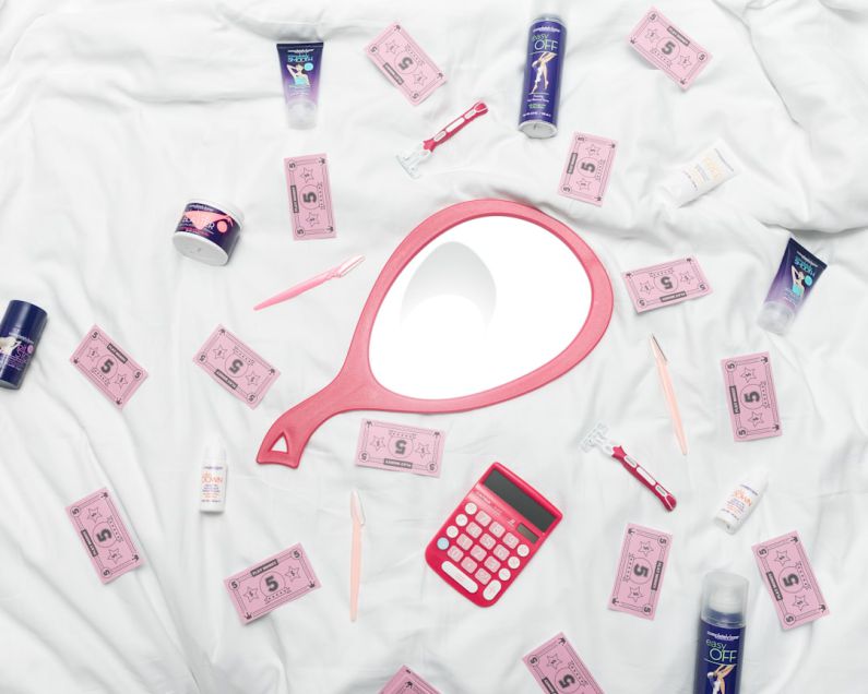 Moisturizer Selection - calculator, hand mirror, and toiletries in white textile